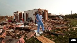  Nathan Ulepich searches outside the back of his house destroyed after a powerful tornado ripped through the area on May 20, 2013 in Moore, Oklahoma. 