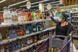 A customer shops for alcoholic beverages at a supermarket ahead of a nationwide lockdown to curb the spread of the COVID-19 pandemic, in Istanbul, April 29, 2021.