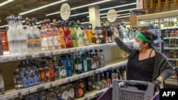 A customer shops for alcoholic beverages at a supermarket ahead of a nationwide lockdown to curb the spread of the COVID-19 pandemic, in Istanbul, April 29, 2021. 