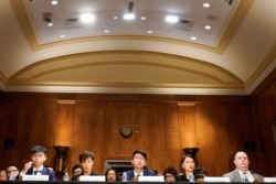 FILE - Joshua Wong, left, secretary-general of Hong Kong's pro-democracy Demosisto party and leader of the Umbrella Movement, testifies at a Congressional-Executive Commission on China (CECC) hearing on Capitol Hill in Washington, Sept. 17, 2019.