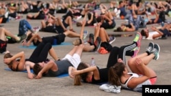 FILE - People gather for physical exercise in Nantes, France, Sept. 18, 2017. 