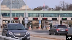 Vehicles cross the Rainbow Bridge, March 18, 2020, in Niagara Falls, New York. 