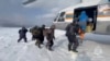 Fishermen, who were stranded on an ice floe drifting in the Sea of Okhotsk in the Western Pacific, board a helicopter during a rescue operation in the Sakhalin region, Russia, Feb. 12, 2025, in this still image taken from video. (Russian Emergencies Ministry/Handout via REUTERS)