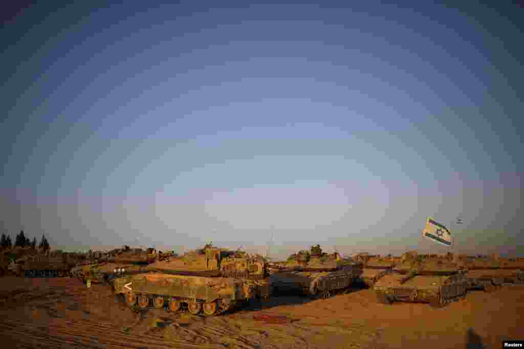 Israeli tanks are waiting for orders in a staging area near the border with the Gaza Strip, Aug. 7, 2014.
