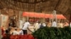 FILE - Men wait to buy food at Khartoum's central food market.