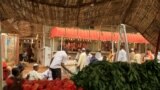 FILE - Men wait to buy food at Khartoum's central food market.