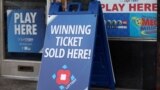  FILE - Lottery ticket signs advertising the Mega Millions and Powerball games can be seen in Washington on July 17, 2023. 