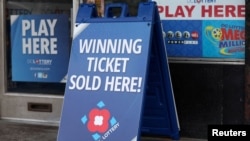  FILE - Lottery ticket signs advertising the Mega Millions and Powerball games can be seen in Washington on July 17, 2023. 
