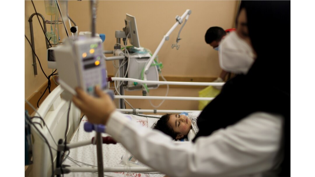 A wounded Palestinian girl lies on a bed in Shifa hospital in Gaza City, May 17, 2021.