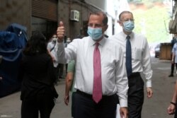Health and Human Services Secretary Alex Azar thumbs up as he visits a mask factory with Director of the American Institute in Taiwan William Brent Christensen, right, in New Taipei City, Aug. 12, 2020.