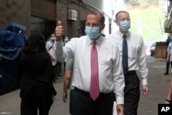 Health and Human Services Secretary Alex Azar thumbs up as he visits a mask factory with Director of the American Institute in Taiwan William Brent Christensen, right, in New Taipei City, Aug. 12, 2020.