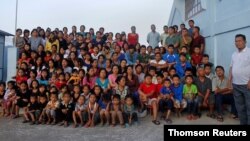 Family members of Ziona poses for group photograph outside their residence in village Baktawng, June 14, 2021.