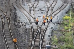 FILE - Workers inspect railway tracks for the Belt and Road freight rail route linking Chongqing, China, with Duisburg, Germany, at the Dazhou railway station in Sichuan province, China, March 14, 2019.