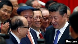 资料照：中国国家主席习近平与香港富豪李嘉诚（左）握手。（2017年6月30日）