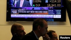 Traders work on the floor of the New York Stock Exchange in New York City, July 12, 2016.