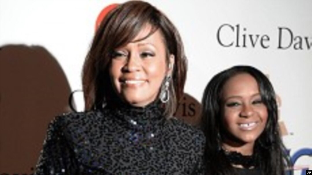 FILE - Whitney Houston and daughter Bobbi Kristina in Beverly Hills, California.