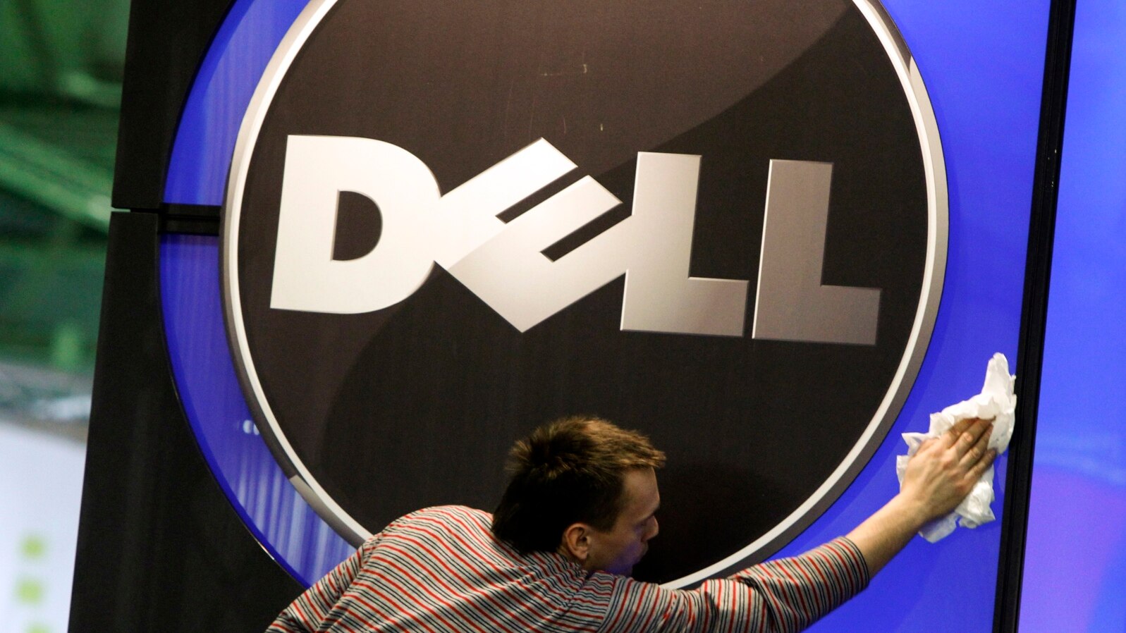 A man wipes a Dell logo at an IT exhibition in Hannover, Germany, in this February 28, 2010, file photo.