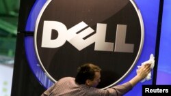 A man wipes a Dell logo at an IT exhibition in Hannover, Germany, in this February 28, 2010, file photo.