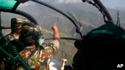 Nepalese army men search for the missing U.S. Marine helicopter in the earthquake affected Dolakha District, Nepal, May 14, 2015.