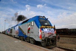 A train moves during the inauguration of a 140-kilometer (90-mile) line running from eastern Iran into western Afghanistan, at a railroad station in Khaf, Iran, Dec. 10, 2020.