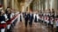 French president Francois Hollande, center, flanked by his companion Valerie Trierweiler, right, Paris' mayor Bertrand Delanoe, second left,and Paris' deputy mayor Anne Hidalgo arrives to deliver a speech as part of a ceremony held at Paris' town hall, Pa