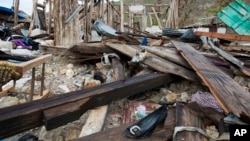 Shoes are scattered among the debris of a home destroyed by Hurricane Matthew, in Port-a-Piment, a district of Les Cayes, Haiti, Oct. 19, 2016. Hopes have dimmed for Haitians combing the countryside for missing relatives in the Caribbean nation’s hardest-hit zone, the remote and long-ignored southwestern tip.