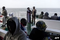 FILE—Passengers talk on the ferry that travels between Dakar and Ziguinchor on April 10, 2024.