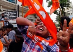 Shiv Sena party supporters celebrate outside their party office in Mumbai, India, Oct. 24, 2019.