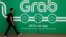 Seorang pria berjalan melewati kantor Grab di Singapura, 26 Maret 2018.