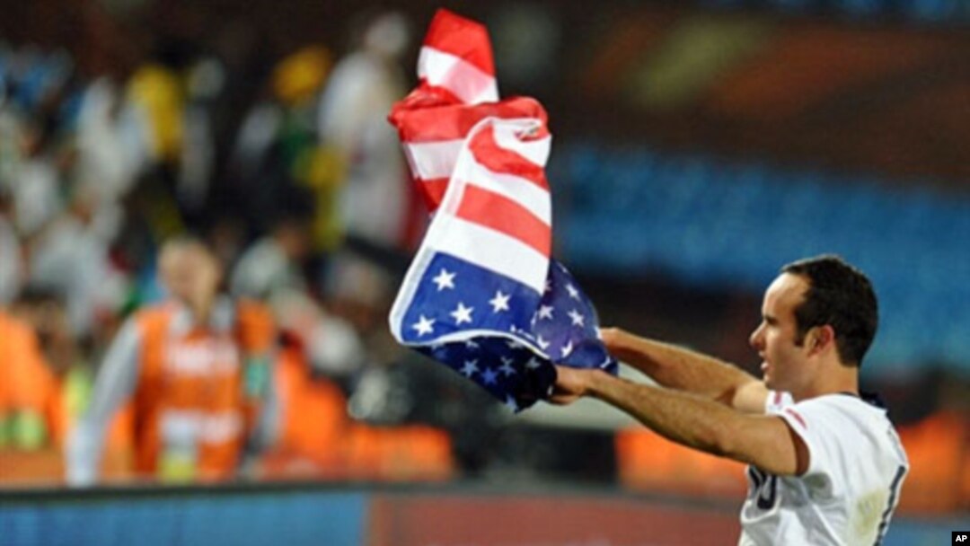 US midfielder Landon Donovan waves the flag after the Group C first round 2010 World Cup football match US versus Algeria at Loftus Verfeld stadium in Tshwane/Pretoria, 23 Jun 2010