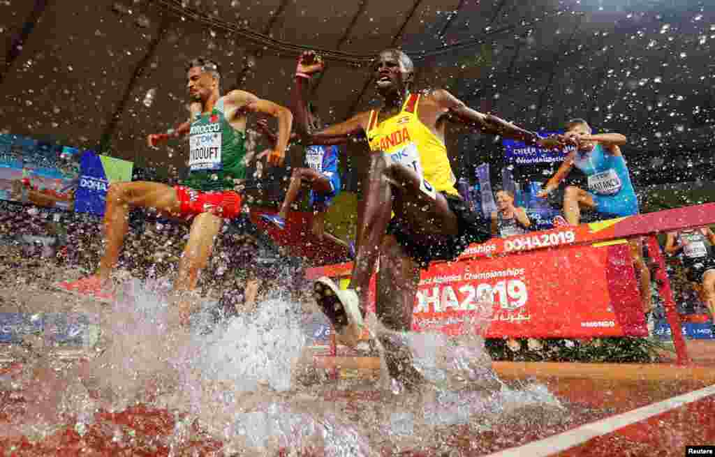 Uganda&#39;s Benjamin Kiplagat, left, and Morocco&#39;s Mohamed Tindouft, right, compete in the Men&#39;s 3000m steeplechase heats at the 2019 IAAF Athletics World Championships in Doha, Qatar.