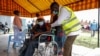 A Kenyan man receives a dose of the AstraZeneca coronavirus vaccine donated by Britain, at the Makongeni Estate in Nairobi, Kenya.