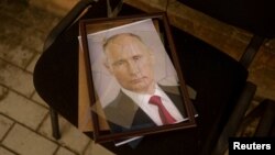 FILE: : A portrait of Russian President Vladimir Putin is seen at a preliminary detention center which Ukrainians say was used by Russian service members to jail and torture people before they retreated, Kherson, Ukraine. Taken Nov.15, 2022.