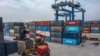 FILE - In this photo released by Xinhua News Agency, a truck transfers a container at the Tuanjiecun Station in the Chongqing International Logistics Hub Park in southwest China's Chongqing Municipality on May 5, 2024. 