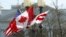 A Canadian flag flutters between a U.S. flag and a Washington, D.C., flag in front of the White House in Washington, March 7, 2016. Preparations are under way for the official state visit of Canada's Prime Minister Justin Trudeau on Thursday. 