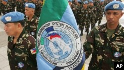 FILE - Philippine soldiers stand at attention as they display their contingent flag during the send-off ceremony, Jan. 22, 2008 at the headquarters of the Armed Forces of the Philippines in suburban Quezon City, north of Manila.