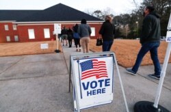 FILE - Voters line up early in the morning to cast their ballots in the U.S. Senate run-off election, at a polling station in Marietta, Georgia, Jan. 5, 2021.