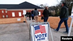 FILE - Voters line up early in the morning to cast their ballots in the U.S. Senate run-off election, at a polling station in Marietta, Georgia, Jan. 5, 2021.