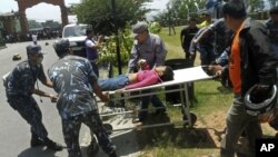 Unidentified survivor of a plane crash is carried for treatment to a nearby city of Pokhara, Nepal. The plane crashed into a mountain in the Himalayas while trying to land at an airport in northern Nepa killing 15 people and critically injuring six.