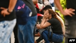 Relatives of people who died in an armed attack wait outside the morgue to remove the bodies in Guayaquil, Ecuador, Feb. 17, 2025.