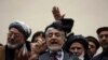 Afghan presidential candidate Abdullah Abdullah, center, addresses the media following a meeting with his party members, in Kabul, Afghanistan, Feb. 18, 2020.