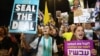 People hold placards showing support for hostages who were kidnapped during the deadly October 7 attack, amid the ongoing conflict in Gaza between Israel and Hamas, in Tel Aviv, Israel, Sept. 3, 2024. 