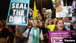 People hold placards showing support for hostages who were kidnapped during the deadly October 7 attack, amid the ongoing conflict in Gaza between Israel and Hamas, in Tel Aviv, Israel, Sept. 3, 2024. 