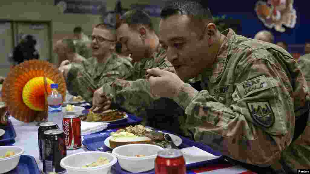 U.S. troops share a Thanksgiving meal at a NATO base in Kabul, Afghanistan, Nov. 27, 2014.