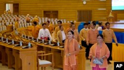 FILE - Lawmakers of National League for Democracy party (NLD) walk in parliament in Naypyitaw, Myanmar, ahead of a parliamentary session, March 15, 2016. 