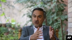 In this Aug 18, 2015, photo, Mohammad Daoud Sultanzoy, a former lawmaker overseeing the handover of military airports for the Afghan government, speaks during an interview with the Associated Press in Kabul.