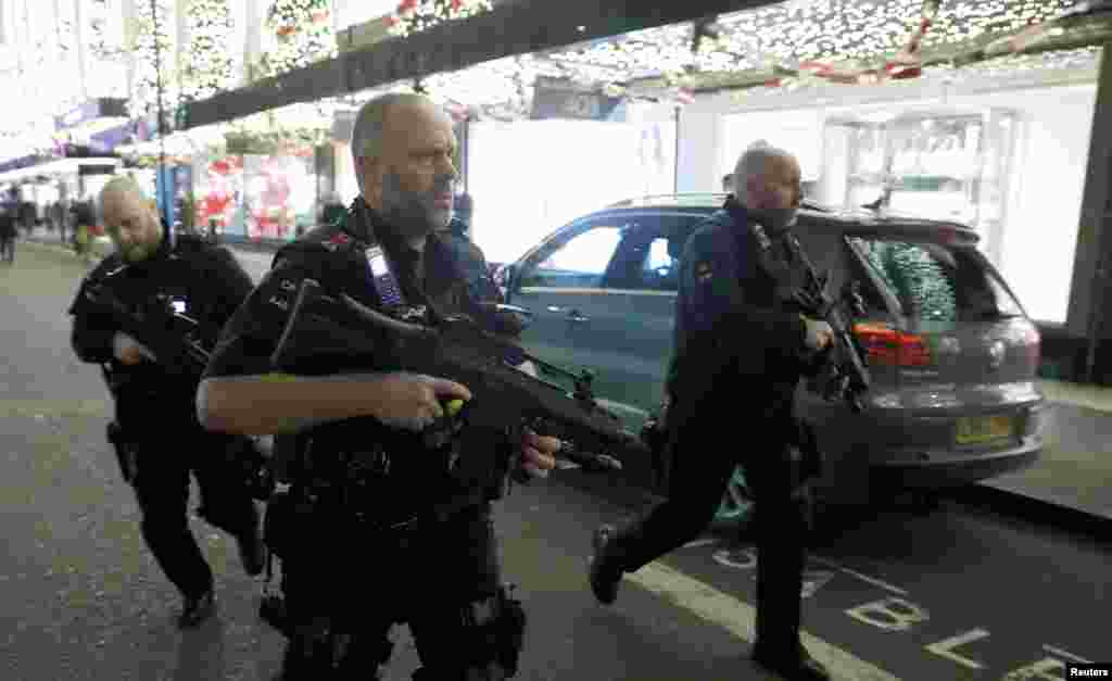 Armed police run along Oxford Street, London, Britain, Nov. 24, 2017. 