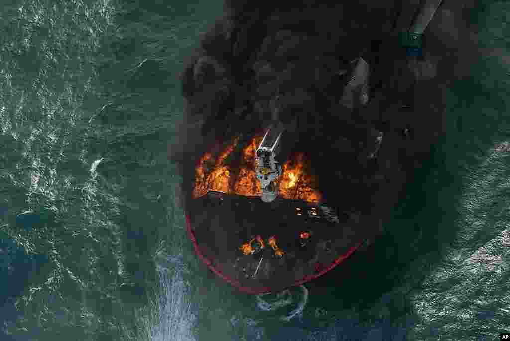 In this photo provided by the Sri Lanka Air Force, smoke rises from the container vessel MV X-Press Pearl that is engulfed in flames, off Colombo port.