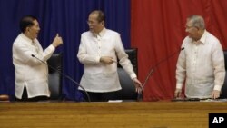 Philippine President Benigno Aquino III, center, is given a thumbs-up sign by Senate President Juan Ponce Enrile, left, while House Speaker Feliciano Belmonte looks on, after he delivers his third State of the Nation address Monday July 23, 2012. 