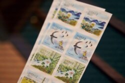 FILE - Swedish teenage environmental activist Greta Thunberg appears on a postal stamp in her native Sweden that is part of a series focusing on the environment, in Stockholm, Jan. 13, 2021.